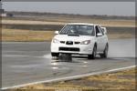 Chris' White STI splashing through a puddle on the front straight #1