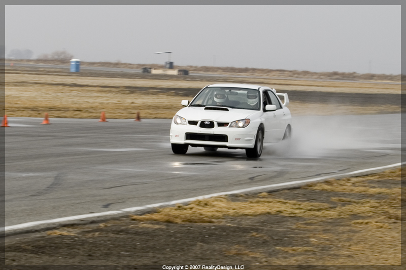 Chris' White STI splashing through a puddle on the front straight #2